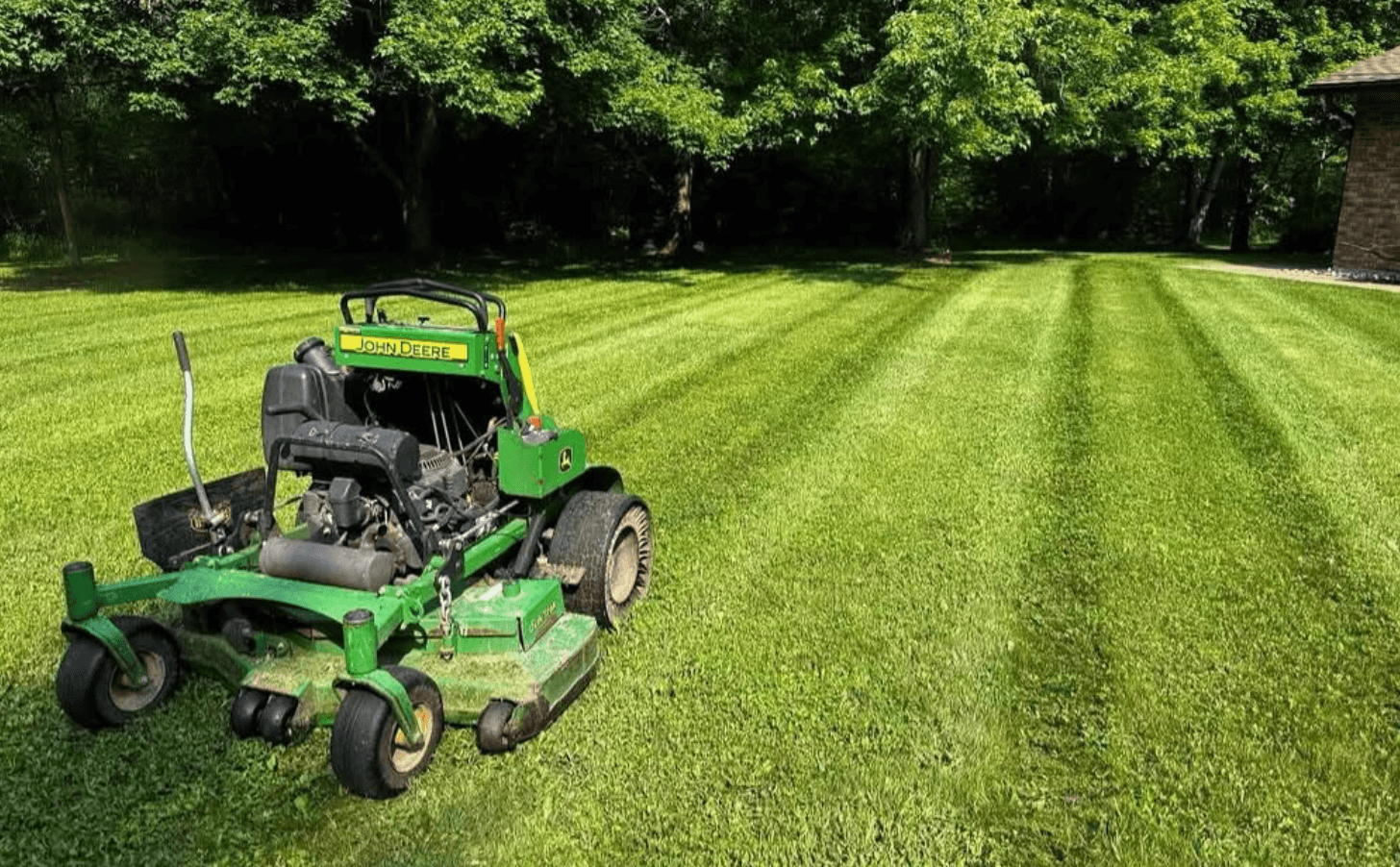 VanDuzen Lawn Care John Deere mower on freshly cut lawn